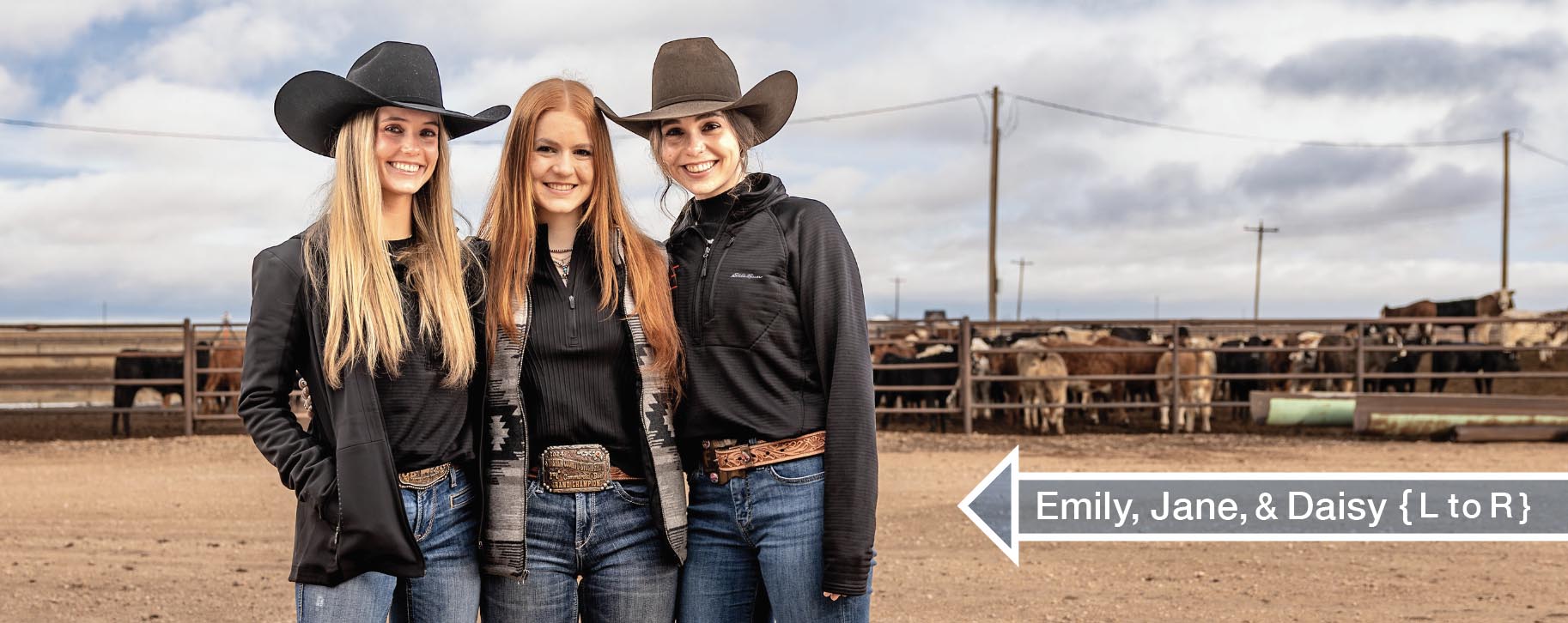 Emily, Jane, and Daisy Berry standing together in front of their cattle feed-yard. They are all wearing black shirts along with bluejeans and two are in cowboy hats